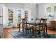 Sunlit dining room featuring a chandelier, wood floors, and a beautiful view outside the windows at 3515 Guilford Ave, Indianapolis, IN 46205