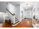 Grand foyer showcasing hardwood floors, a staircase, and an inviting entry area with natural light at 3515 Guilford Ave, Indianapolis, IN 46205