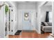 Bright foyer with hardwood floors, a decorative front door, and views into the living room at 3515 Guilford Ave, Indianapolis, IN 46205