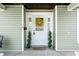 Charming front door with wreath and potted topiaries, adding curb appeal at 3515 Guilford Ave, Indianapolis, IN 46205