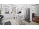 Bright kitchen features white cabinets, stainless steel appliances, and a center island with seating at 3515 Guilford Ave, Indianapolis, IN 46205