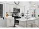 Well-equipped kitchen with stainless steel appliances, center island, and white cabinetry at 3515 Guilford Ave, Indianapolis, IN 46205