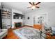 Spacious living room with fireplace, tv, hardwood floors, and glass coffee table at 3515 Guilford Ave, Indianapolis, IN 46205