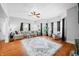 Bright living room with large windows, hardwood floors, a ceiling fan and a comfortable sofa at 3515 Guilford Ave, Indianapolis, IN 46205