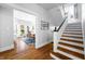 Elegant staircase with wood treads and white risers adjacent to a dining area with bay windows at 3515 Guilford Ave, Indianapolis, IN 46205