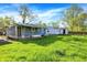 Well-maintained backyard with green grass and trees, creating a serene outdoor space at 3538 Cecil Ave, Indianapolis, IN 46226