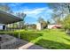 Lush backyard featuring green lawn, covered patio, and vibrant greenery at 3538 Cecil Ave, Indianapolis, IN 46226