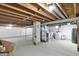 Unfinished basement with exposed ceiling beams, concrete flooring, and essential utilities at 3538 Cecil Ave, Indianapolis, IN 46226