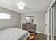Bright bedroom with hardwood floors, a dresser and a closet at 3538 Cecil Ave, Indianapolis, IN 46226