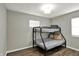 Bedroom featuring bunk beds, hardwood floors, and a window at 3538 Cecil Ave, Indianapolis, IN 46226