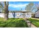 Charming single-story home with light blue siding, a mature tree, and a well-maintained lawn at 3538 Cecil Ave, Indianapolis, IN 46226