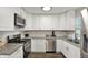 Modern kitchen with white cabinets, granite countertops, and stainless steel appliances for culinary enthusiasts at 3538 Cecil Ave, Indianapolis, IN 46226