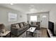 Inviting living room with gray sofas, modern rug, and natural light; perfect for relaxation at 3538 Cecil Ave, Indianapolis, IN 46226
