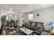 Open-concept living room flows into dining area with gray sofa and stylish decor at 3538 Cecil Ave, Indianapolis, IN 46226
