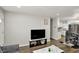 Living room area with a modern entertainment center and an open layout to the dining area at 3538 Cecil Ave, Indianapolis, IN 46226