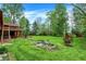 Landscaped backyard featuring a serene pond, mature trees, and lush green lawn at 3875 Arrowhead Ct, Greenfield, IN 46140