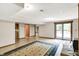 An open basement design with access to a deck, wood burning stove, neutral walls, and a tan rug at 3875 Arrowhead Ct, Greenfield, IN 46140