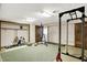 A home gym featuring exercise equipment, carpet, overhead lighting, and access to an exterior door at 3875 Arrowhead Ct, Greenfield, IN 46140