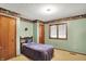 Cozy bedroom with natural light, featuring a single bed, wood door and patterned wallpaper at 3875 Arrowhead Ct, Greenfield, IN 46140