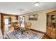 Inviting dining area adjacent to kitchen, featuring a wooden table, charming decor and lots of light at 3875 Arrowhead Ct, Greenfield, IN 46140
