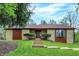 Stone facade home with a brown roof, complemented by manicured green lawn and a wooden pathway at 3875 Arrowhead Ct, Greenfield, IN 46140