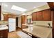 Bright and spacious kitchen featuring wood cabinetry, a window over the sink, and ample countertop space at 3875 Arrowhead Ct, Greenfield, IN 46140
