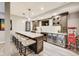 Finished basement bar area featuring a wine fridge, sink, and a countertop with seating for five at 3997 Spylaw Rd, Bargersville, IN 46106