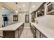 Finished basement bar area featuring a wine fridge, sink, and a countertop with seating for five at 3997 Spylaw Rd, Bargersville, IN 46106