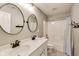 Bathroom offers double sinks, granite countertop, modern fixtures, and shower with white tiling at 3997 Spylaw Rd, Bargersville, IN 46106