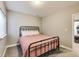 Bedroom features a metal frame bed with soft pink bedspread and lots of light from the window at 3997 Spylaw Rd, Bargersville, IN 46106