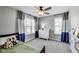 Inviting bedroom with ample natural light, a ceiling fan, and coordinated bedding and curtains at 3997 Spylaw Rd, Bargersville, IN 46106