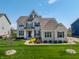 Stunning two-story home boasts manicured landscaping, gray brick facade, and a welcoming front entrance at 3997 Spylaw Rd, Bargersville, IN 46106