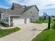 Spacious three-car garage with a large driveway, ideal for multiple vehicles and outdoor activities at 3997 Spylaw Rd, Bargersville, IN 46106