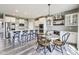 Bright, open kitchen with white cabinetry, stainless steel appliances, and adjacent dining area under a pendant light at 3997 Spylaw Rd, Bargersville, IN 46106