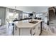 Bright kitchen boasts a large island with a white countertop, stainless steel sink, and open floor plan at 3997 Spylaw Rd, Bargersville, IN 46106