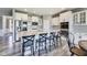 Modern kitchen featuring a large island with black bar stools, stainless appliances, and white cabinetry at 3997 Spylaw Rd, Bargersville, IN 46106