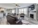 Open floor plan featuring a living room with leather sofas, a fireplace, and seamless flow into the kitchen and dining area at 3997 Spylaw Rd, Bargersville, IN 46106