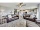 Spacious living room area with dark leather sofas, a decorative rug, and an open view to the bright kitchen area at 3997 Spylaw Rd, Bargersville, IN 46106