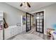 Bright playroom featuring a built-in storage unit, playful decor, and an adjacent hallway through glass doors at 3997 Spylaw Rd, Bargersville, IN 46106