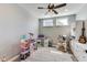 Bright playroom features stylish storage, light gray walls, and a ceiling fan with light fixture at 3997 Spylaw Rd, Bargersville, IN 46106
