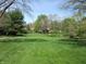 Expansive backyard featuring trees and a lush, green lawn at 4166 Cobblestone Way, Greenwood, IN 46143