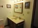 Traditional bathroom features a vanity with countertop and decorated with lighthouse artwork at 4166 Cobblestone Way, Greenwood, IN 46143