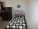 Bedroom with a comfortable bed, dresser, and small cat picture on the wall at 4166 Cobblestone Way, Greenwood, IN 46143