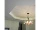 Close-up of a stylish chandelier with a decorative ceiling and trim at 4166 Cobblestone Way, Greenwood, IN 46143