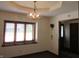 The dining room has a large window and a classic chandelier at 4166 Cobblestone Way, Greenwood, IN 46143