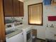 Laundry room with a washer, dryer, sink, shelving and storage in a well-lit area at 4166 Cobblestone Way, Greenwood, IN 46143