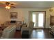 Comfortable living room with ceiling fan, wood floors, and a view of the backyard through glass paneled doors at 4166 Cobblestone Way, Greenwood, IN 46143