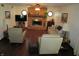 Open-concept living room with wood floors, brick fireplace, ceiling fan and plenty of room for entertaining at 4166 Cobblestone Way, Greenwood, IN 46143