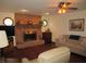 Cozy living room features a brick fireplace, windows, and comfortable seating at 4166 Cobblestone Way, Greenwood, IN 46143
