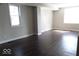 Open-concept living room with hardwood floors and plenty of natural light from two windows at 418 N 14Th St, Elwood, IN 46036